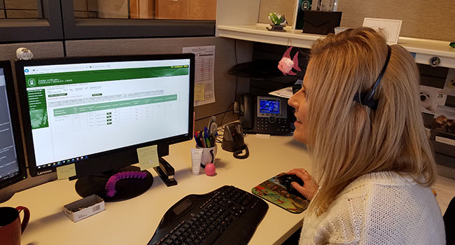 Woman working in ABEM portal on desktop